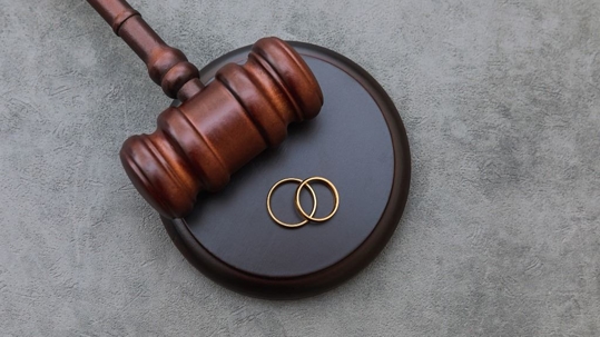 Gavel and two rings on a table