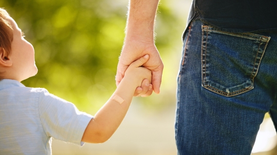 child holding parent's hand