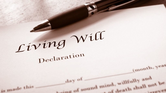 Pen on a document reading "living will"