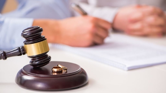 Gavel with wedding rings