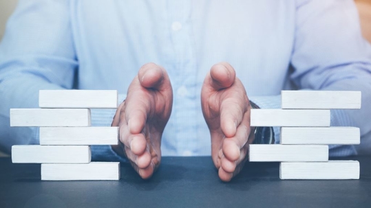 Hands between two opposing structures