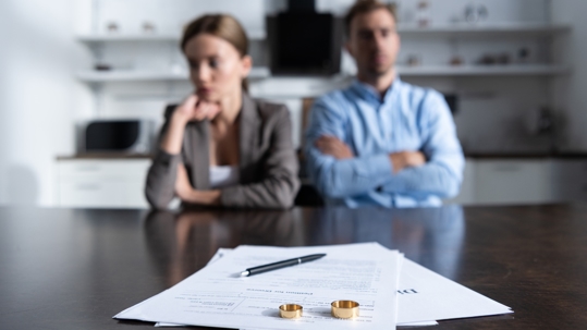 Arguing couple with wedding rings on a table